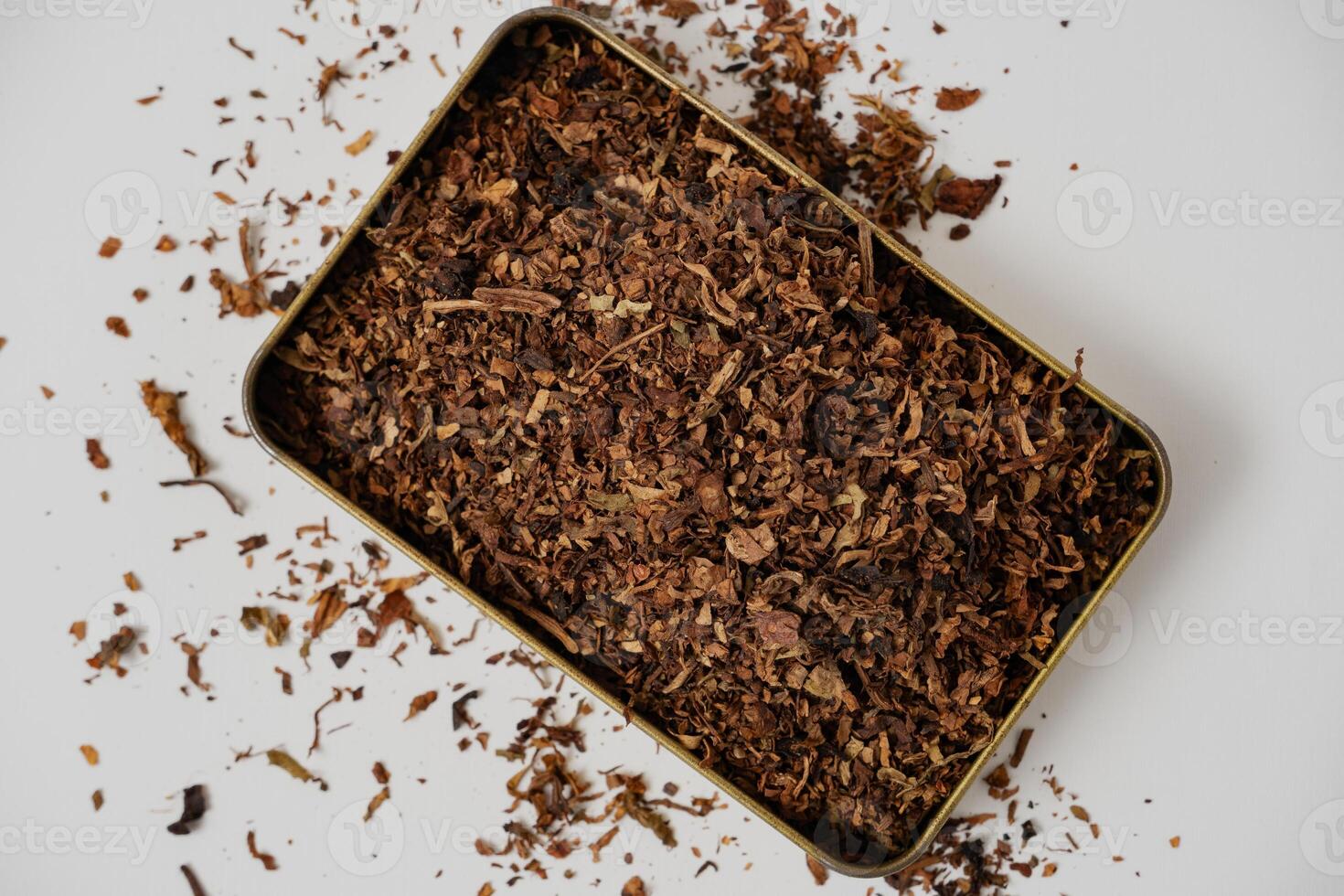 fine tobacco in a gold box with a white background photo