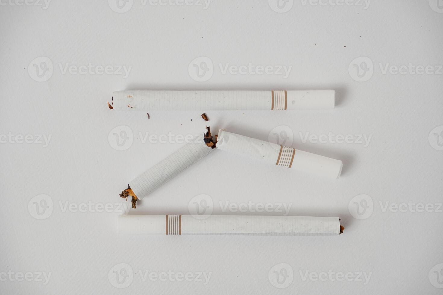a broken cigarette on a white background photo