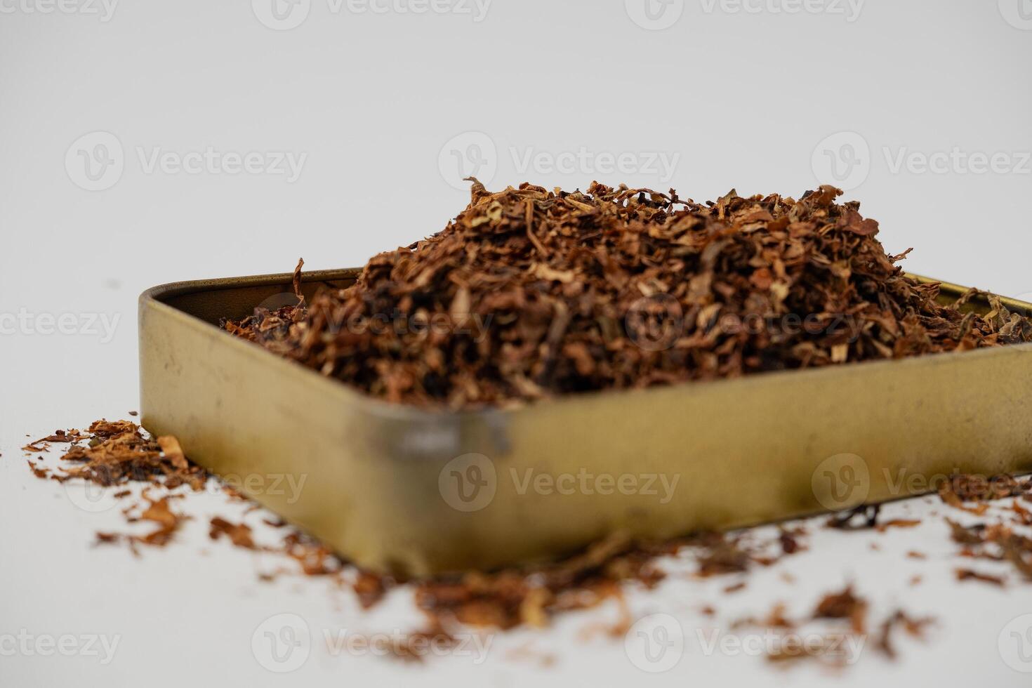 fine tobacco in a gold box with a white background photo
