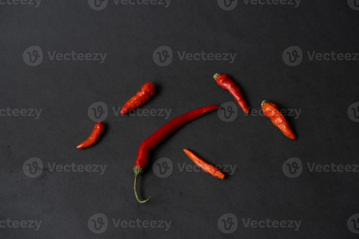 some red chillies on the dark table photo