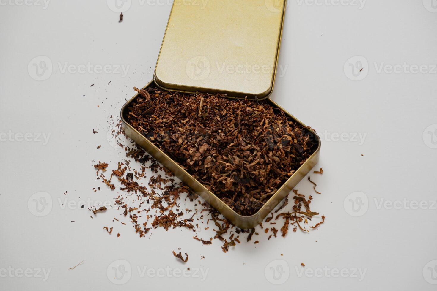 fine tobacco in a gold box with a white background photo