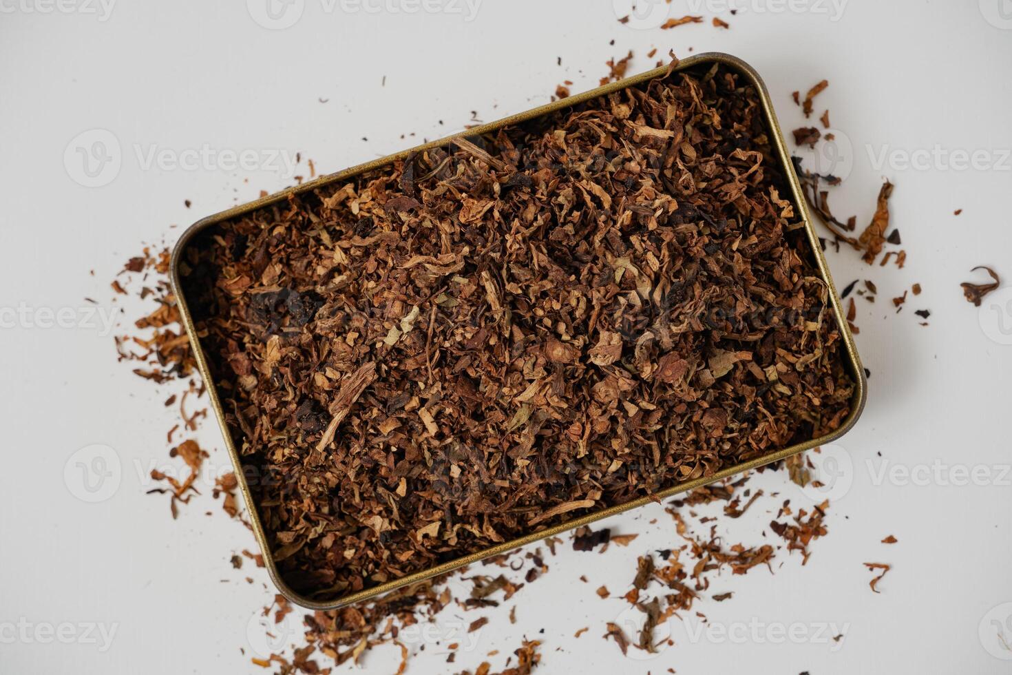 fine tobacco in a gold box with a white background photo
