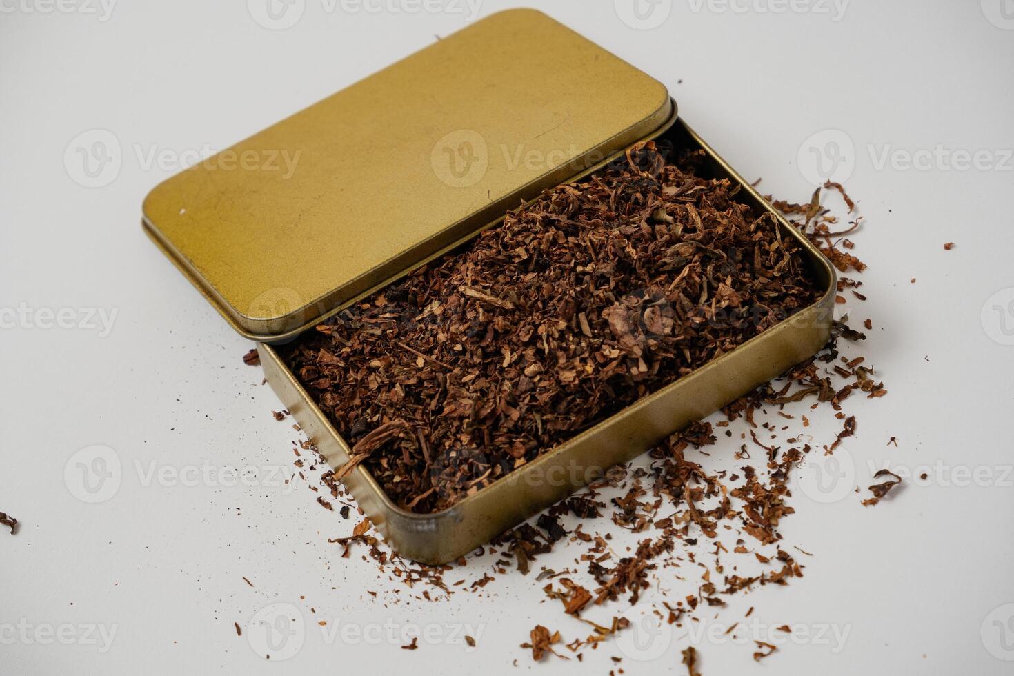 fine tobacco in a gold box with a white background photo