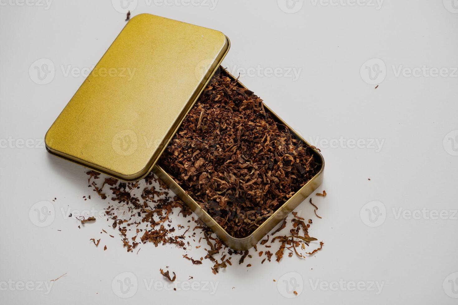 fine tobacco in a gold box with a white background photo