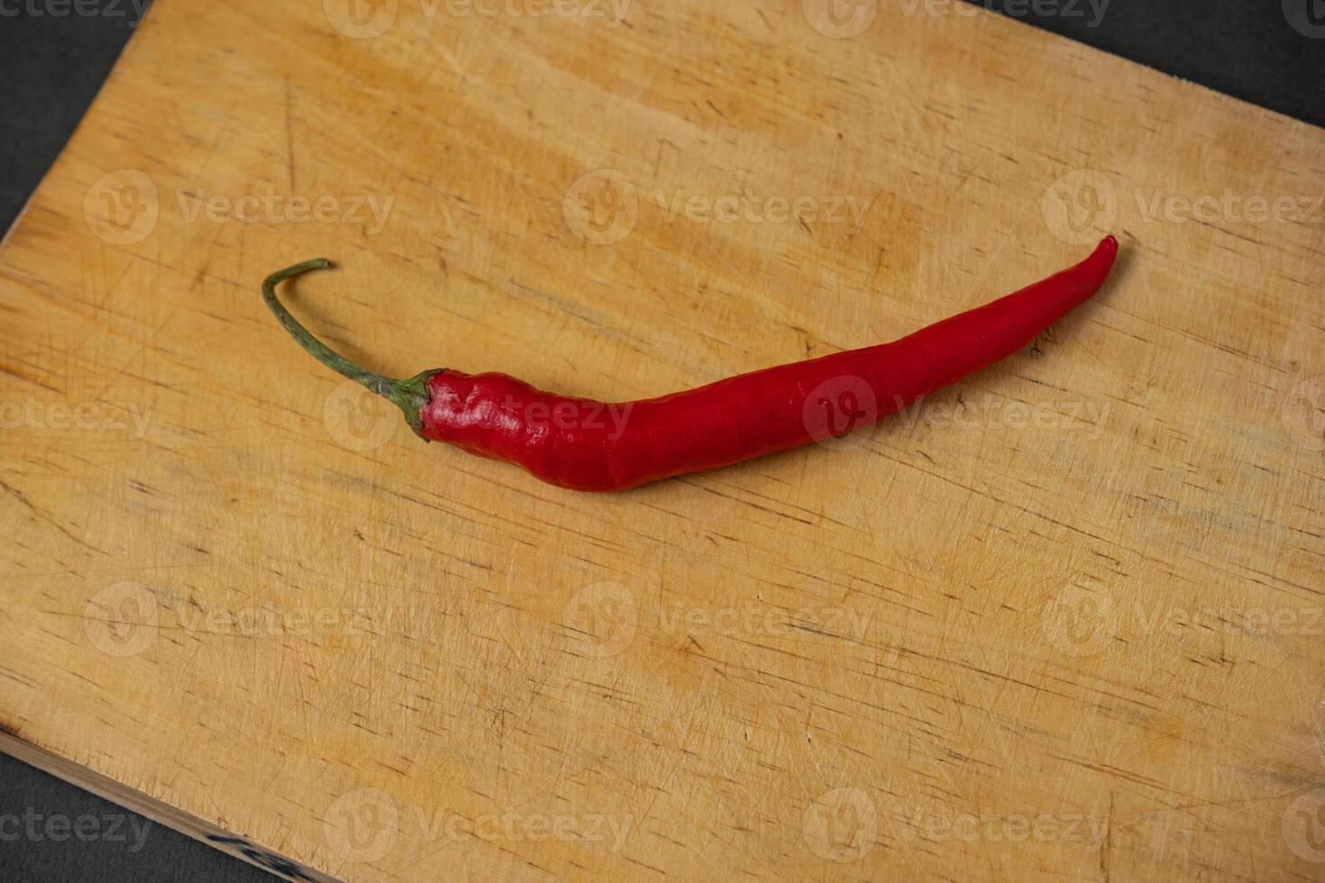 red chillies on a wooden cutting board photo