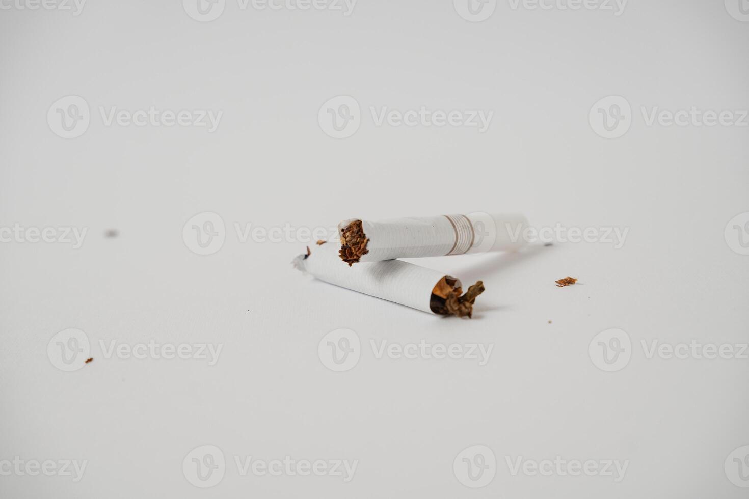a broken cigarette on a white background photo