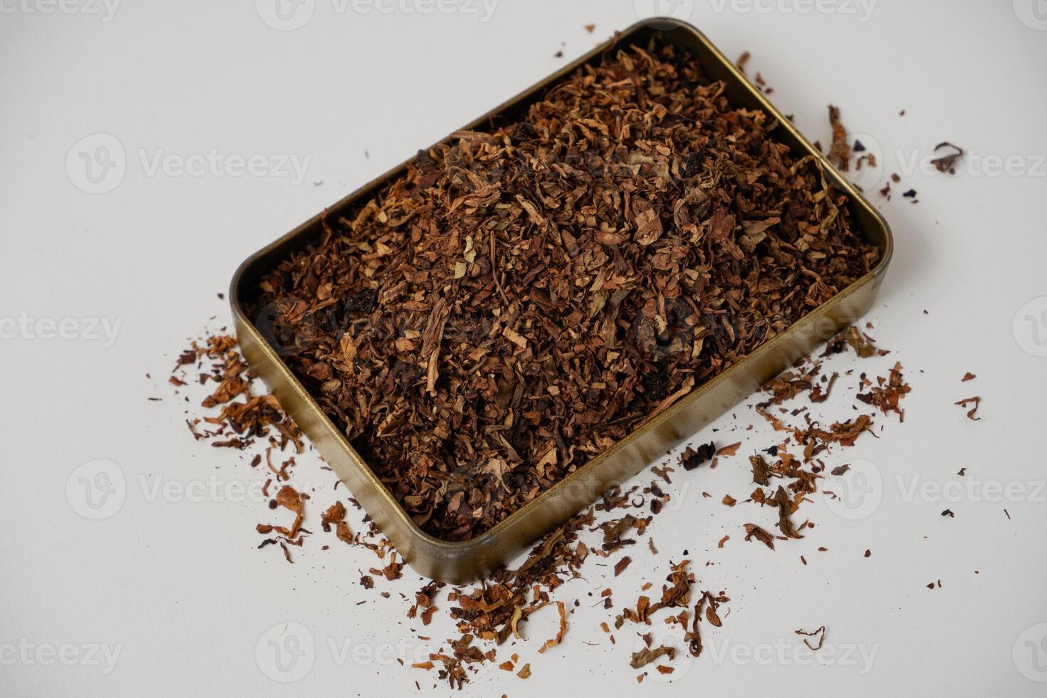 fine tobacco in a gold box with a white background photo