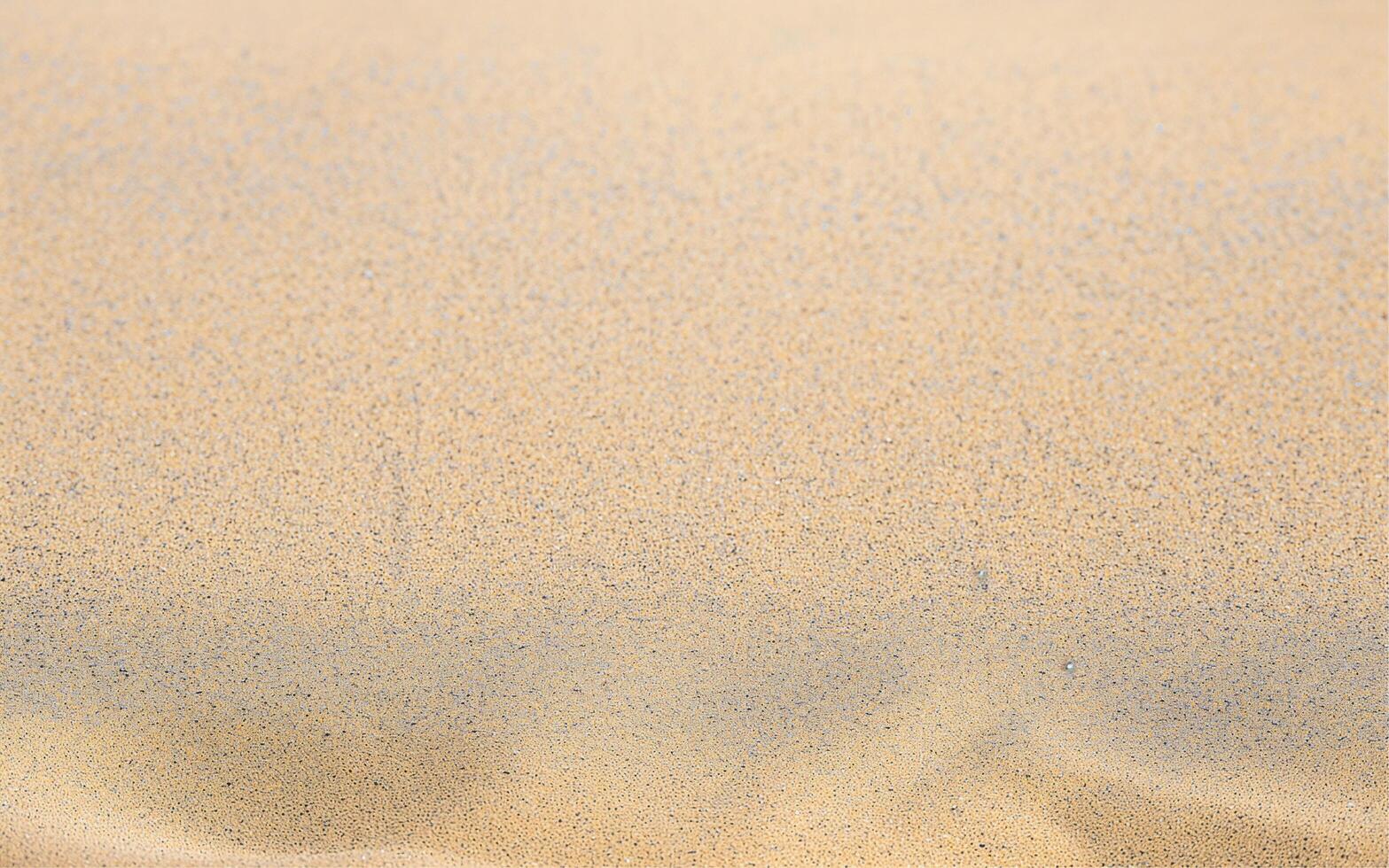 Natural yellow sand on the beach background photo