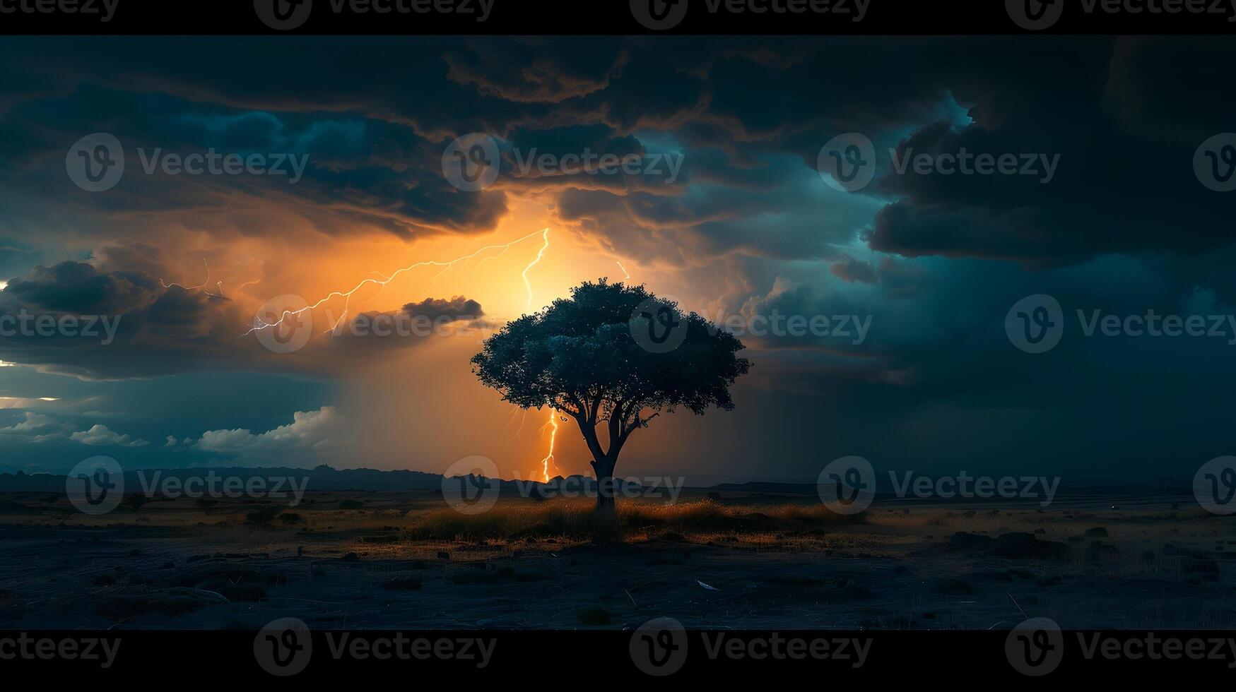 A lone tree in a vast, empty landscape silhouetted against a backdrop of dark storm clouds and multiple lightning strikes illuminating the scene photo