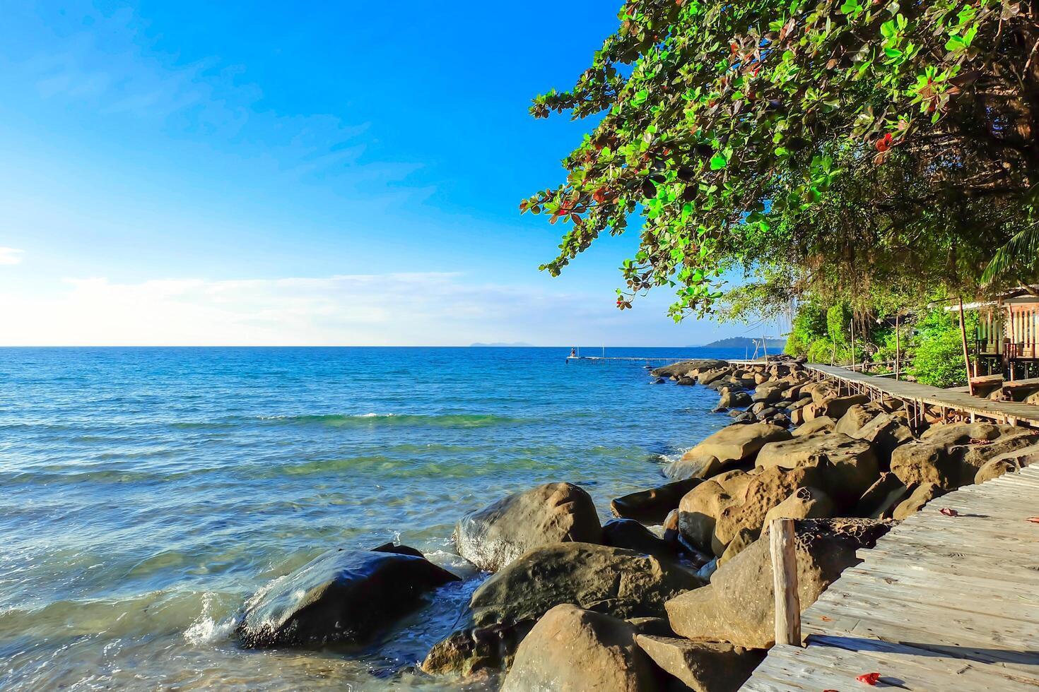 Wooden bridge walkway with rocky coast. sky and cloud natural background on vacation and relax time. photo