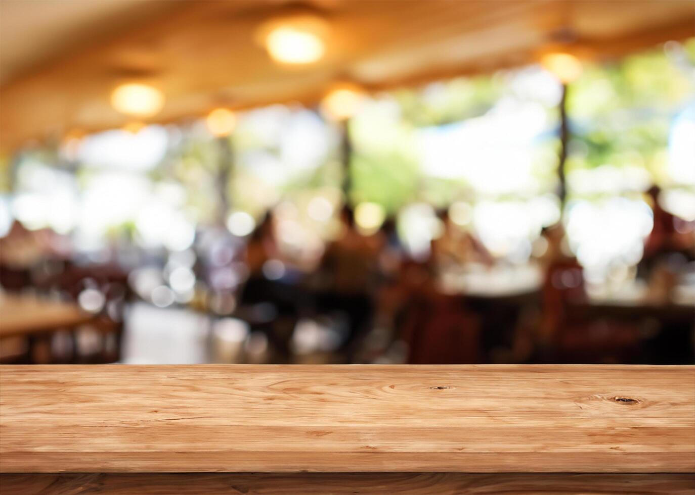 Wood table with restaurant photo