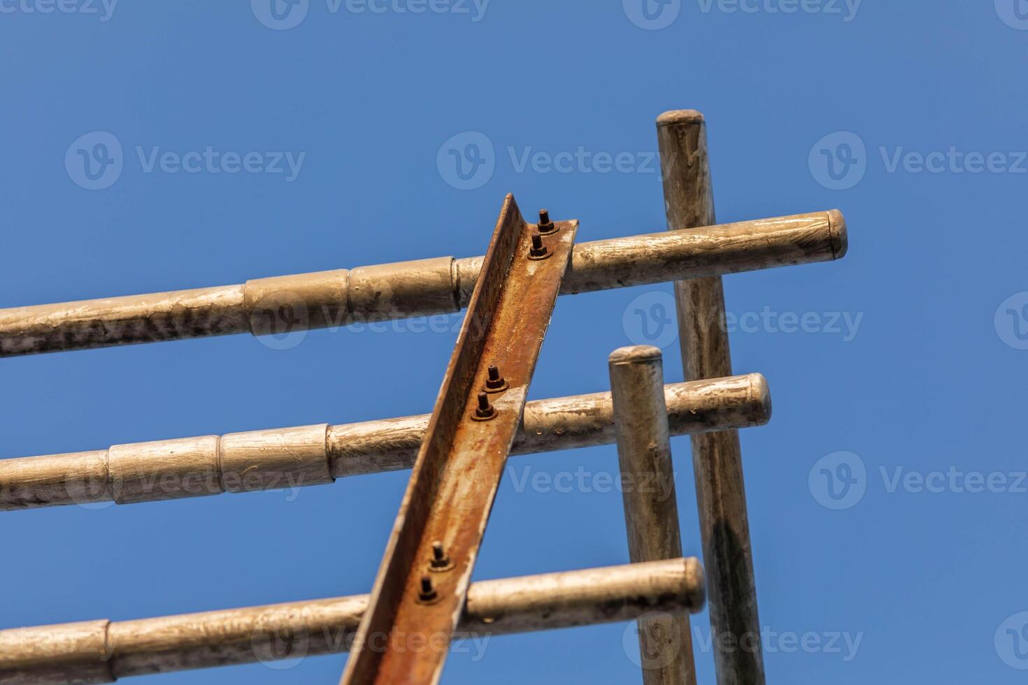back side of the end of some really old metal bleachers photo