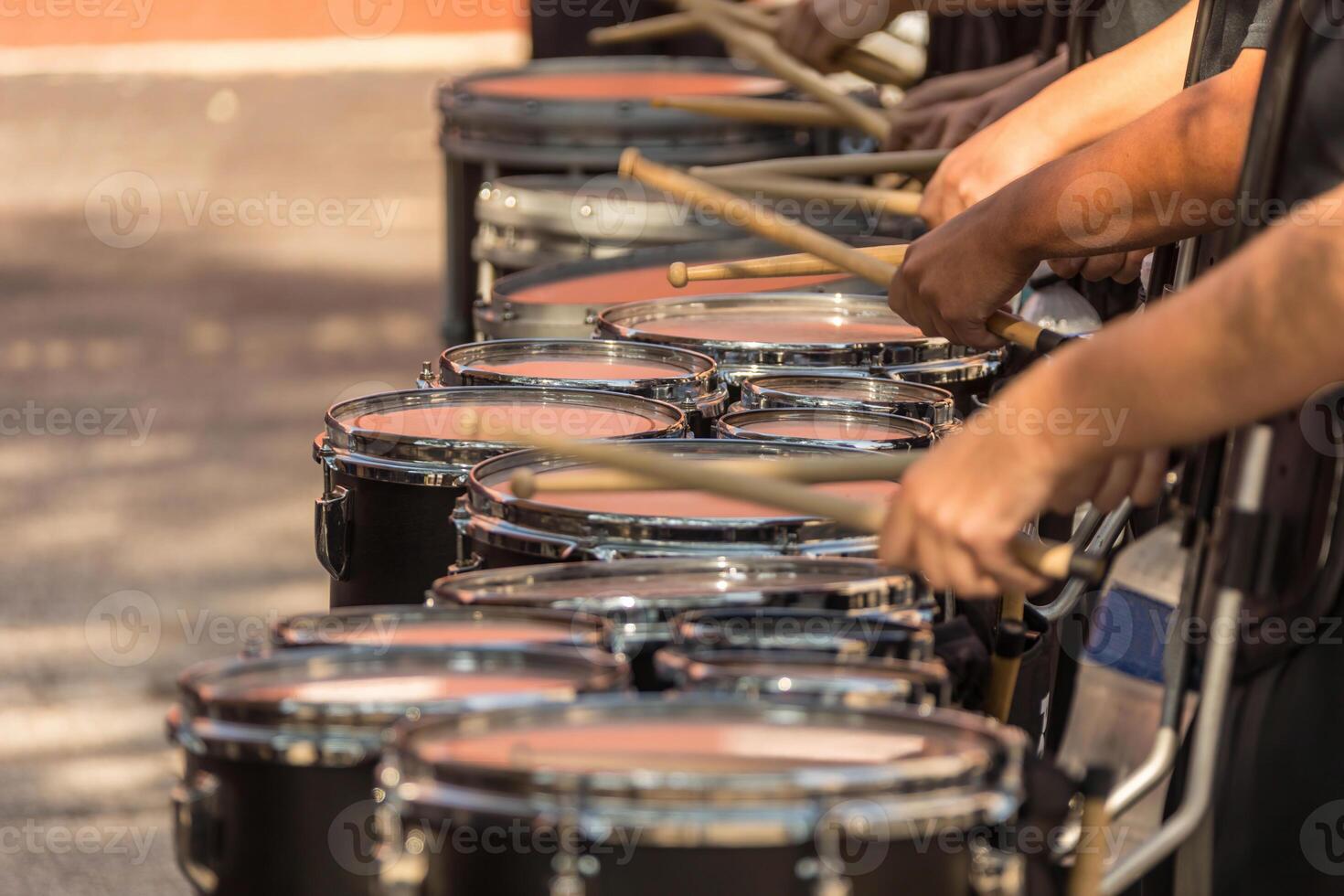 section of a marching band drum line warming up for a parade photo