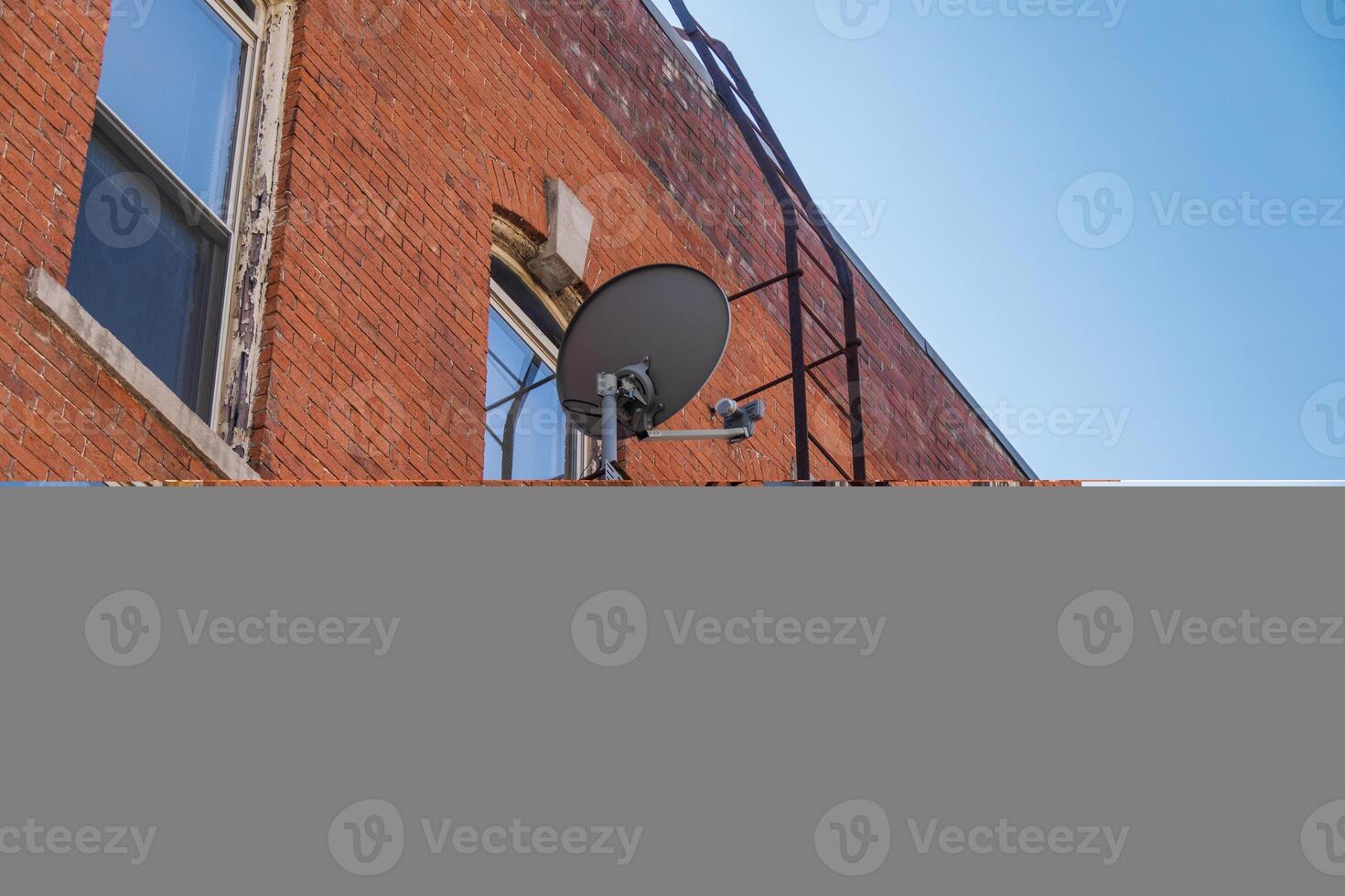 fire escape on the side of a building and a satellite dish photo