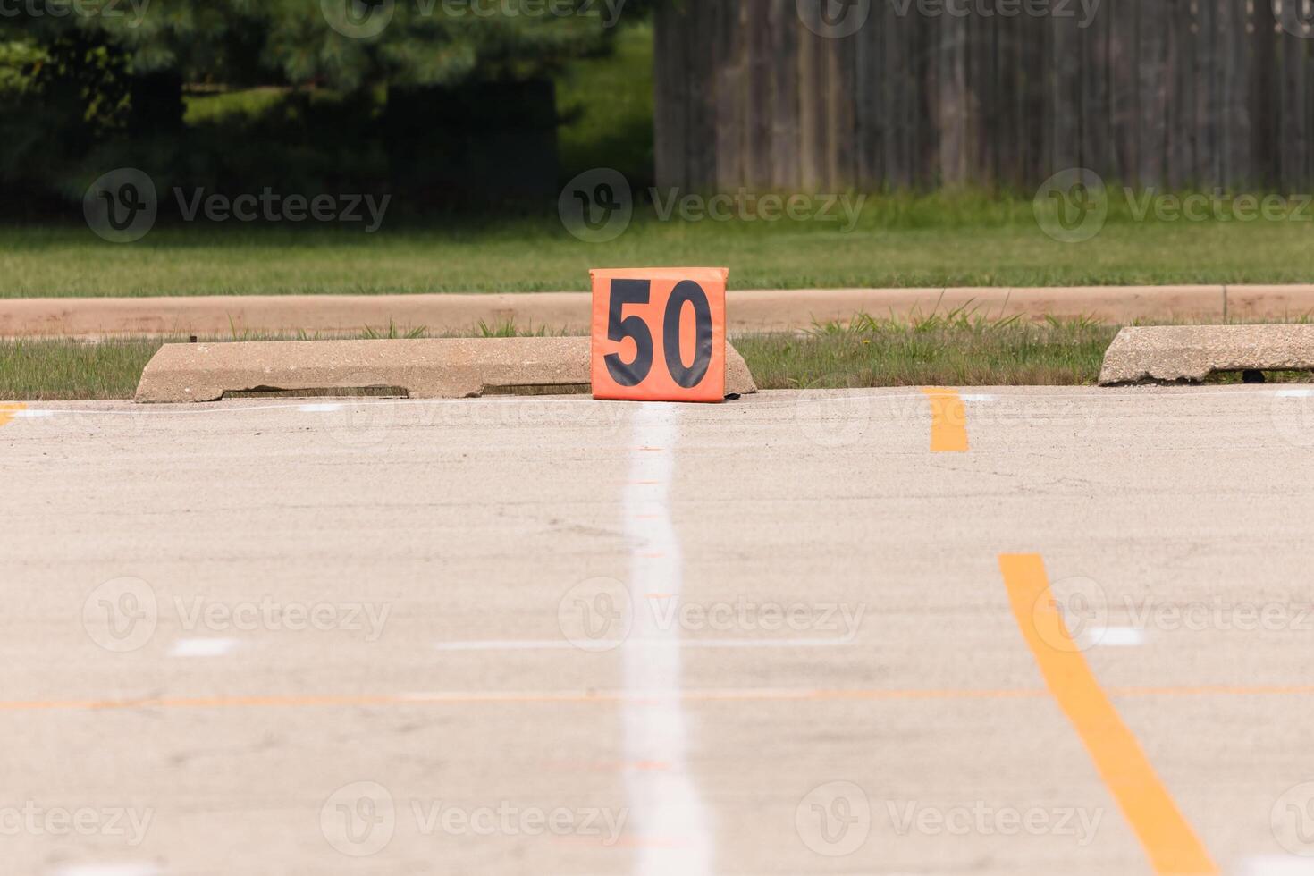 fifty yard line marker ready for rehearsal at marching band rehearsal photo