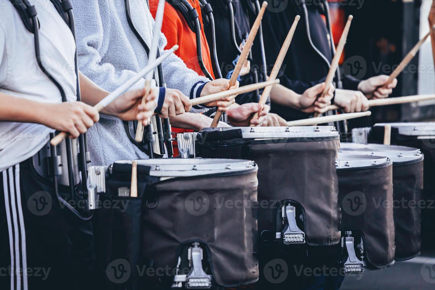 section of a marching band drum line warming up before rehearsal photo