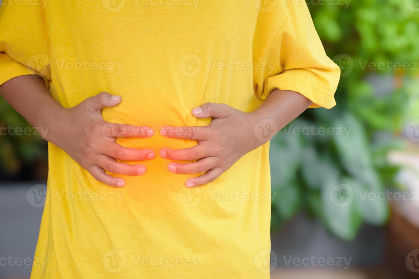 Asian man hands touching stomach due to abdominal pain cause is from abdominal pain and gastritis or enteritis and appendicitis or prostate cancer concept of medical and health care. photo