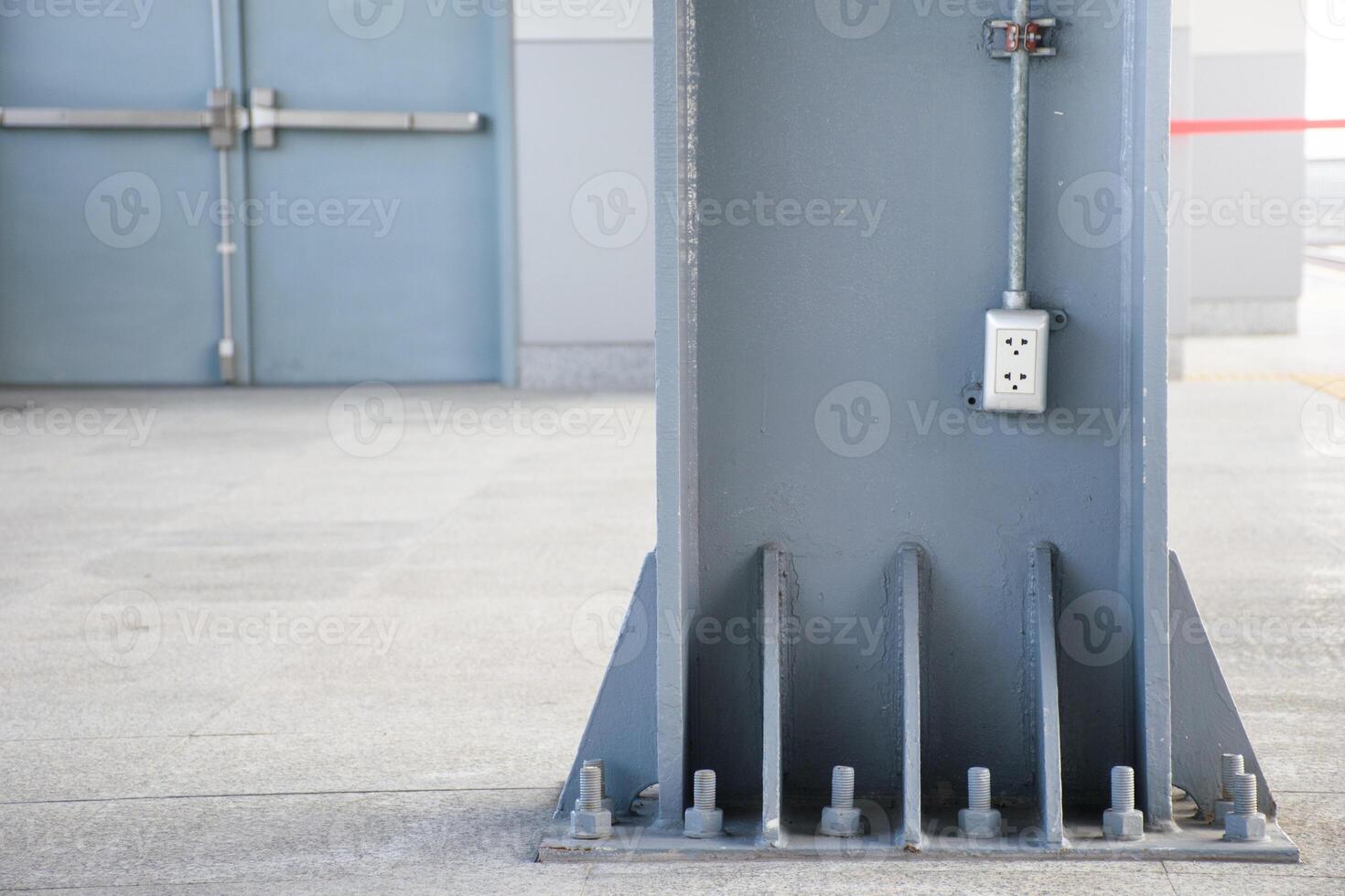 Socket or Receptacle stuck on the wall of a large scrap on the background of a building door for electrical systems concepts in buildings and homes. photo
