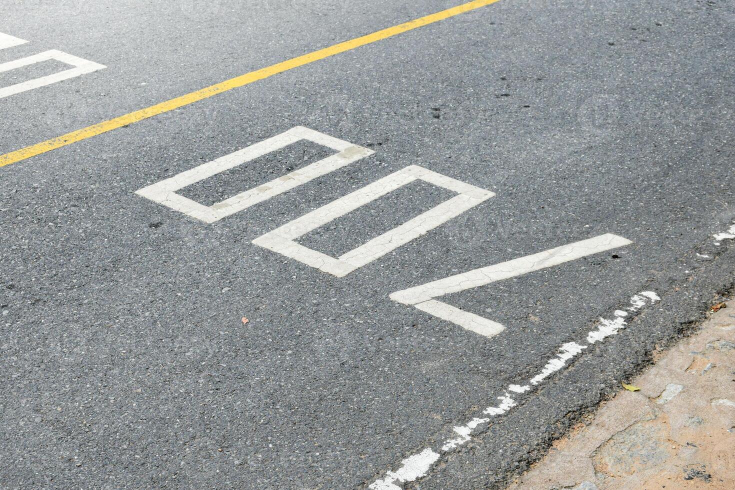 Road surface and yellow traffic lines with numbers seven hundred or 700 on soft sunlight background. photo