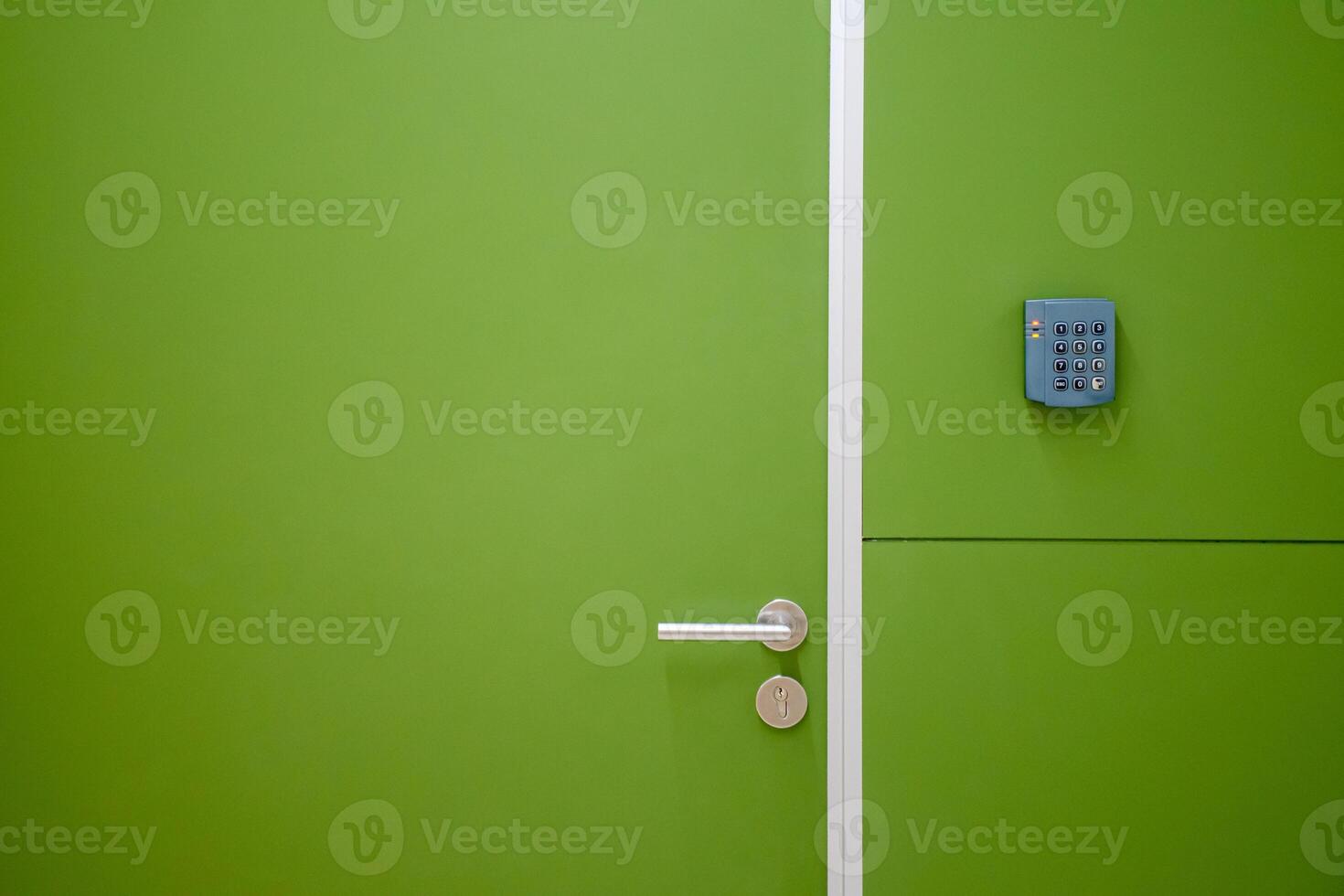 Close-up green door with coded door lock or code keypad on a soft green background and light for concept of Interior design and home safety. photo