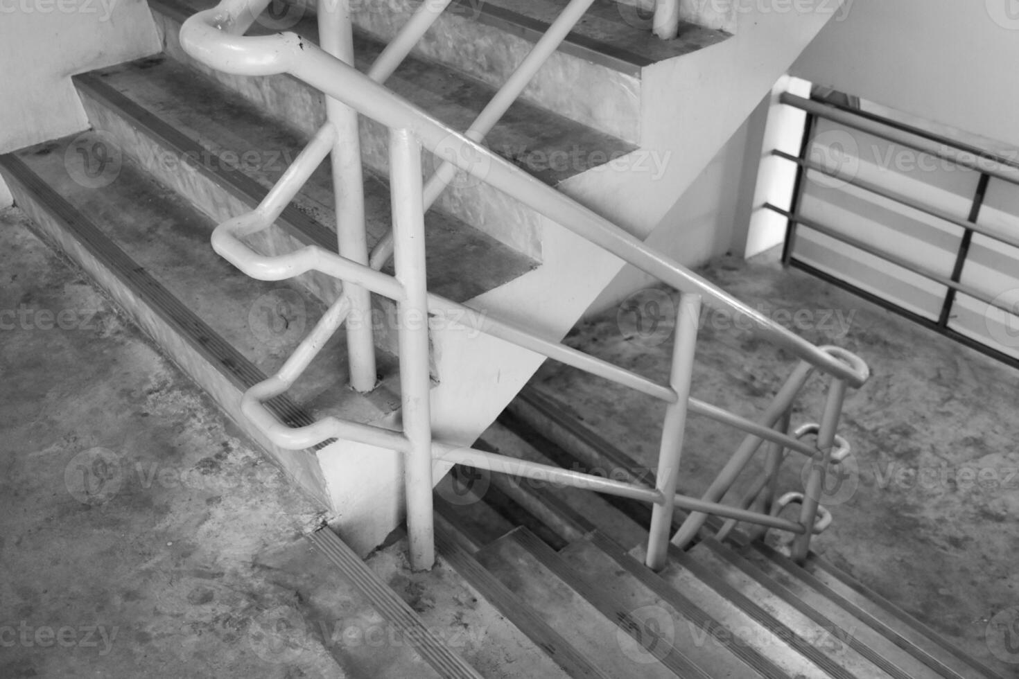 Concrete stairs in a building or fire escape in a gray background tone, used for decoration and design. photo