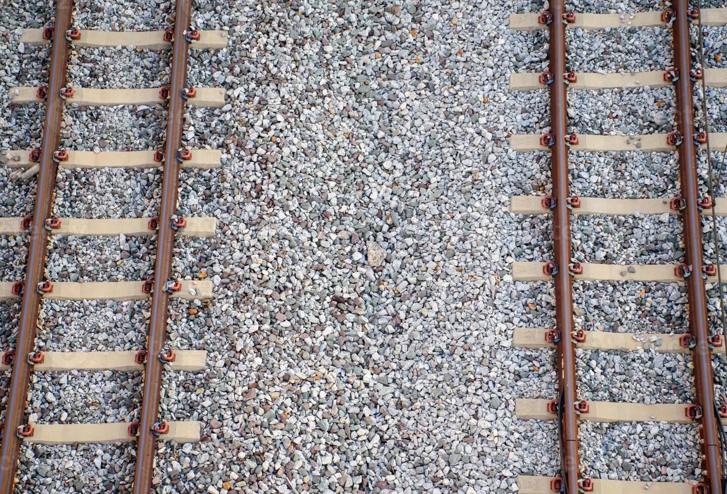 Double-track railway tracks on white gravel taking from top-view are public railway tracks in Bangkok. photo