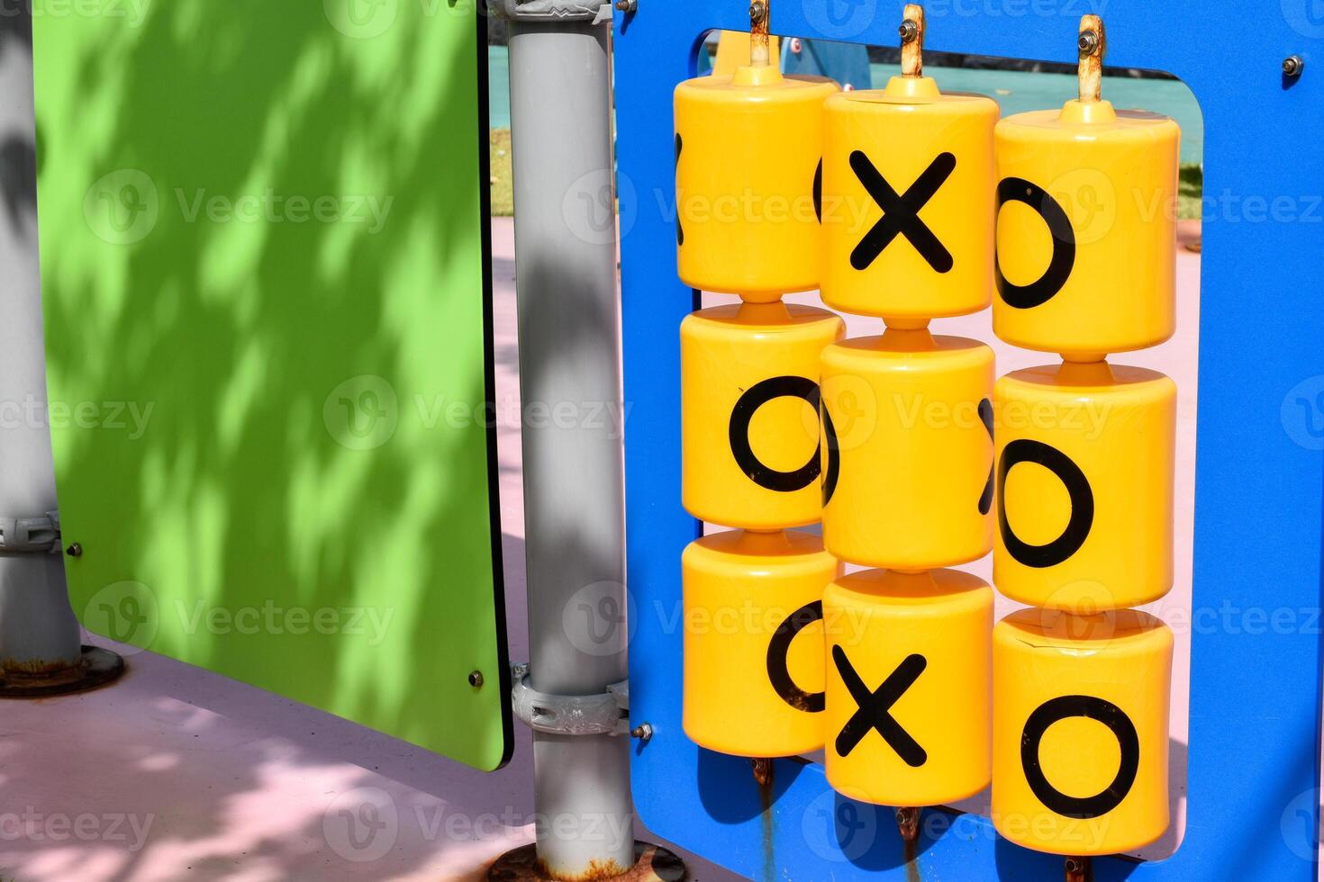 Yellow plastic educational alphabet x and o black letters called tic-tac-toe game or XO board game at playgroup outdoor. photo