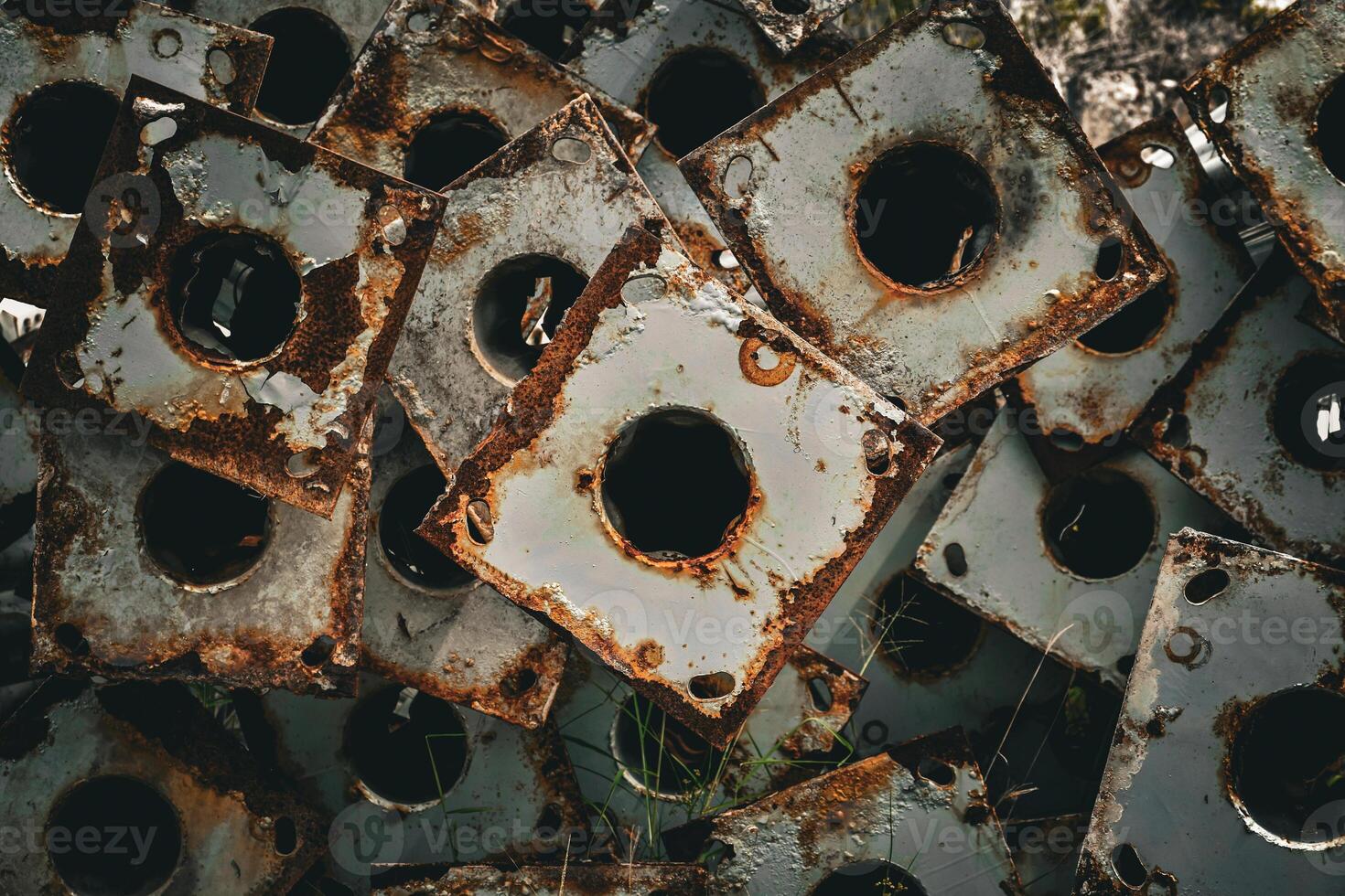 Old and rusty industrial scrap triangular shape with circles steel used to make light poles in dark tones vintage background. photo