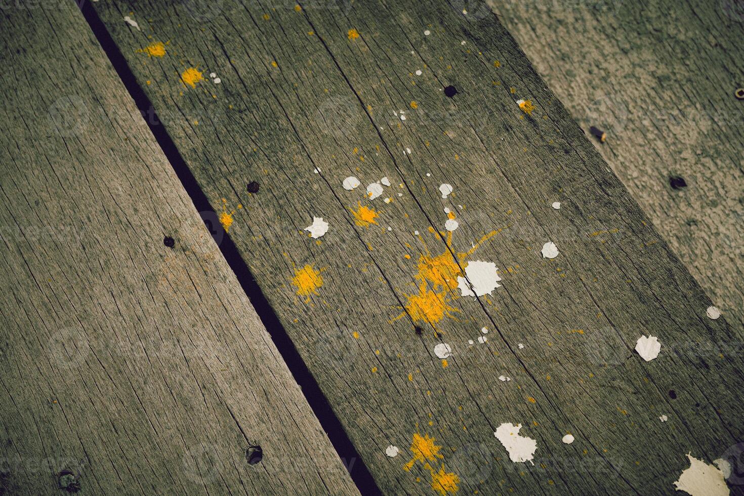 The paint stains on the wood have a beautiful pattern that showcases the texture of the wood and the color perfectly against the vintage tone background. photo
