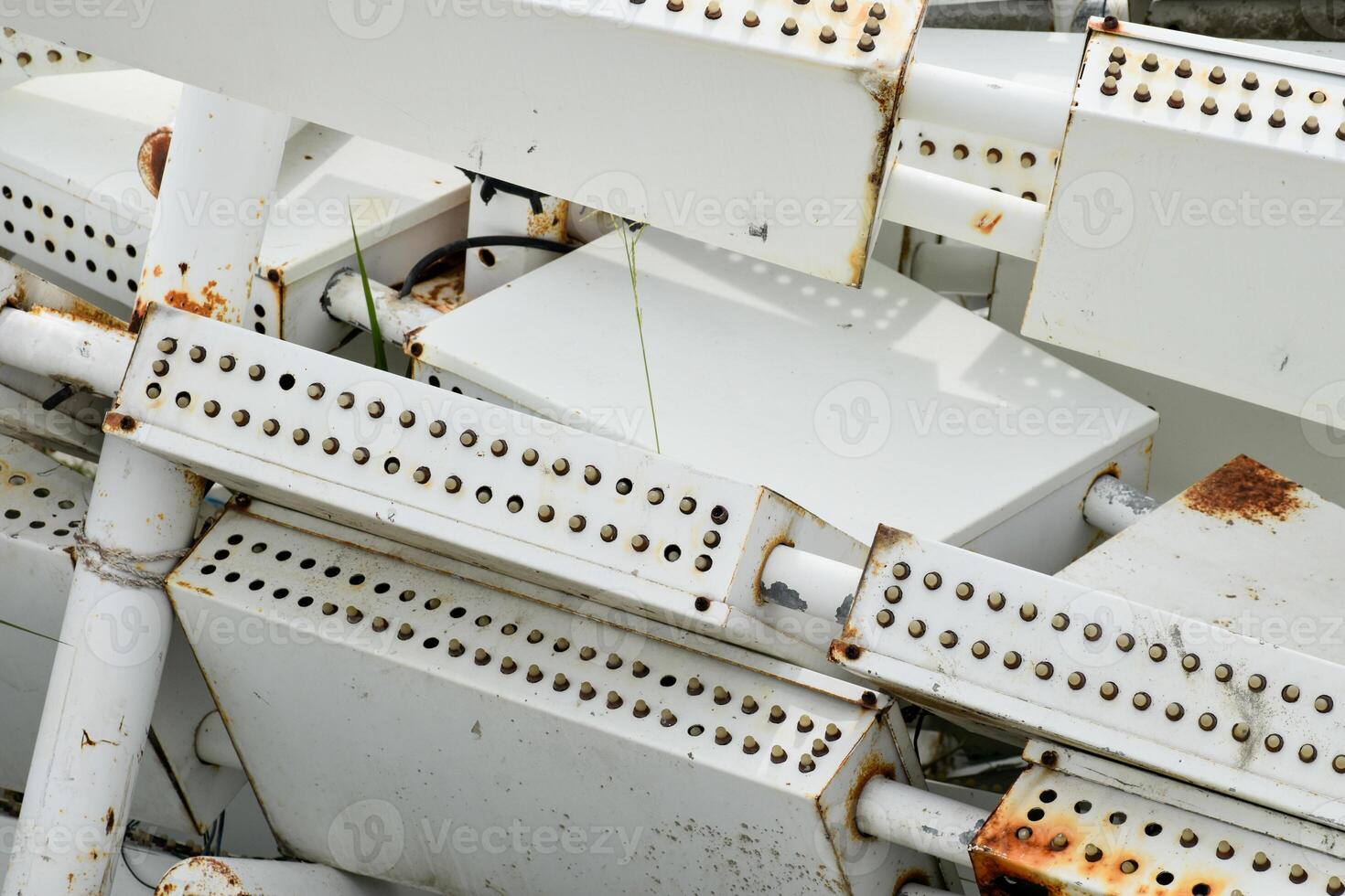 Close-up of old and rusty white industrial scrap iron used as modern architectural decoration for buildings or lights and signs. photo