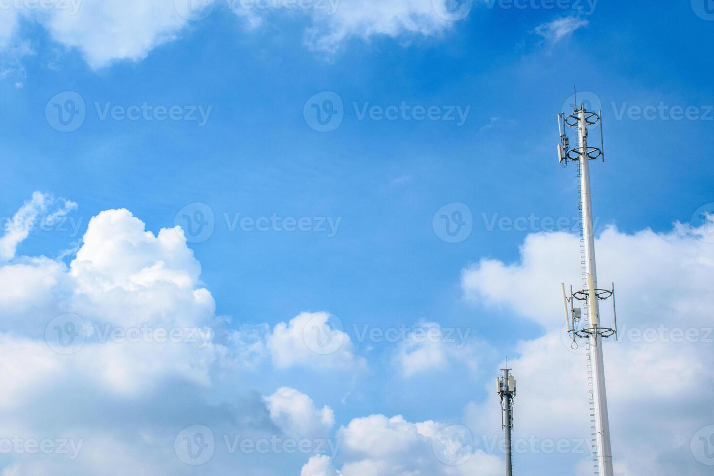 Network signal towers or communication towers for wireless communication concept against beautiful blue sky background. photo