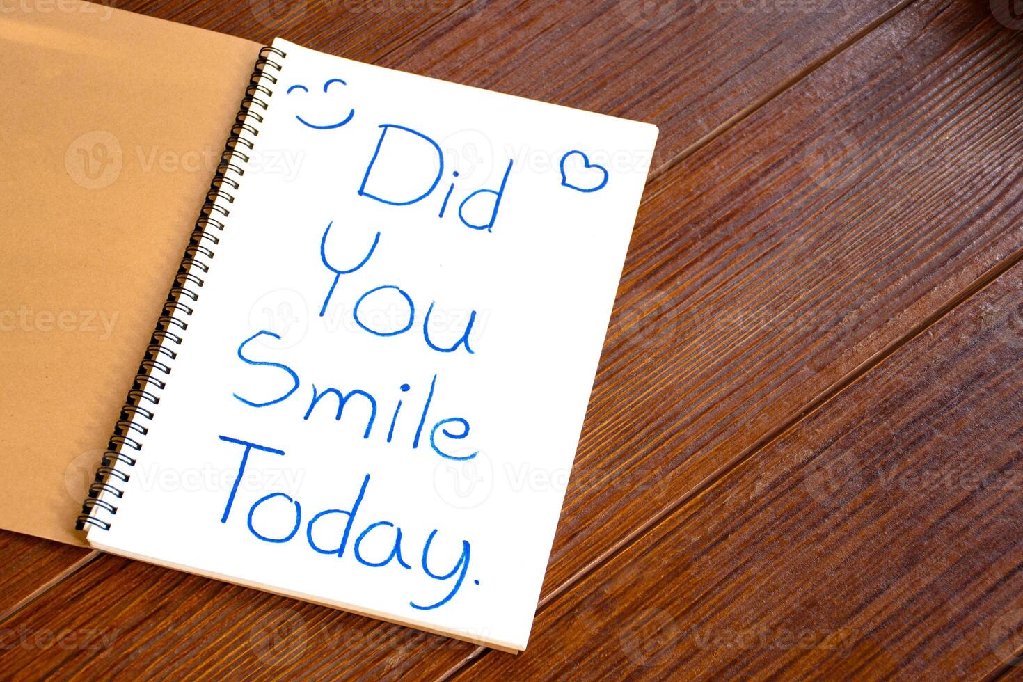 Text of Did You Smile Today write on the white paper of the notebook an encouraging article or question. photo
