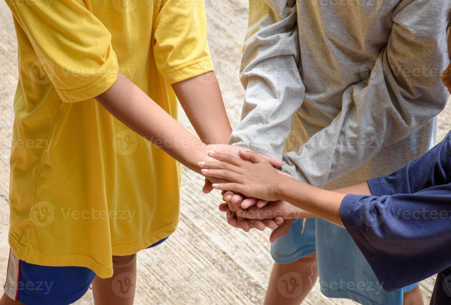 Teamwork children touch hands. Group of diverse kids hands together joining the team for community for concept of collaboration play and togetherness. photo
