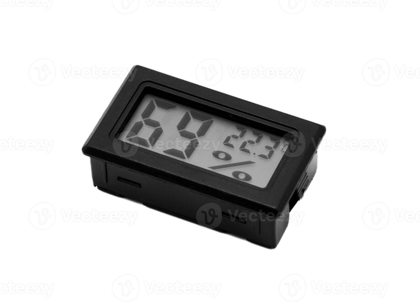 Close-up of small black thermometer and humidity meter that displays a numeric LCD display on a white isolated background. photo