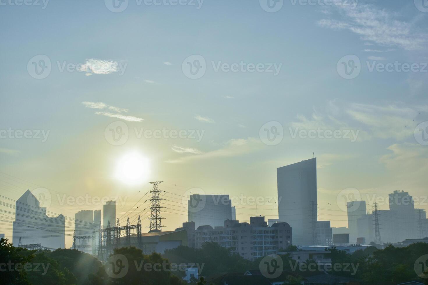 Panorama view of the cityscape or downtown with modern buildings and residences and green forest natural area in the center of the city on the background of blue sky and sunlight sunrise. photo