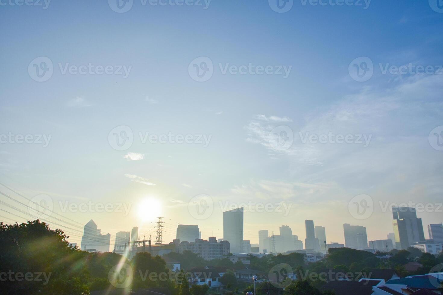 Beautiful sunlight sunset in the evening and view of dowtntown and the Thai capital with residential houses and modern buildings on a skyline background and a clear sky. photo