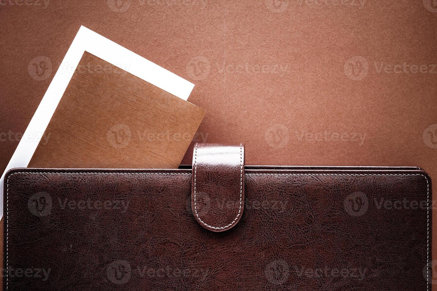 Vintage business briefcase on the office table desk, flatlay background photo