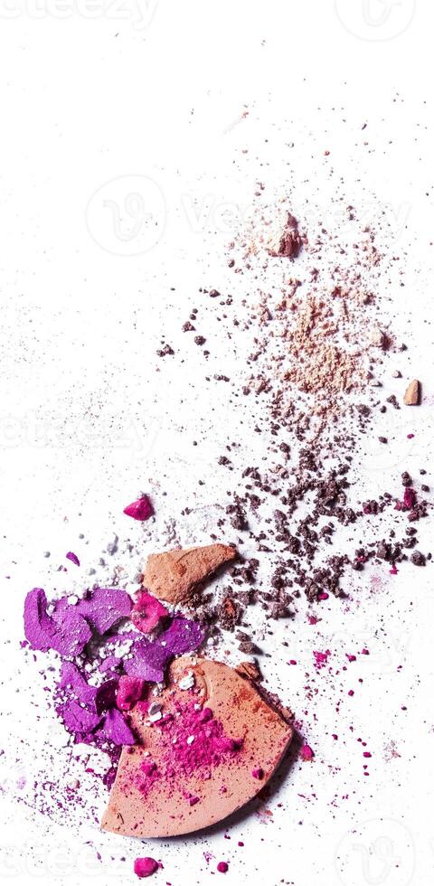 Crushed eyeshadow palette and powder close-up isolated on white background photo