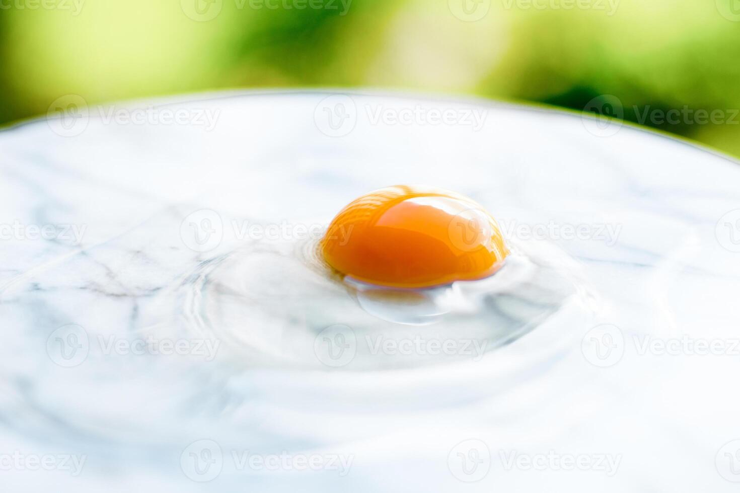 egg yolk on marble - recipe ingredients and homemade cooking concept photo