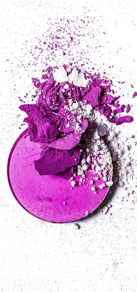 Crushed eyeshadow palette close-up isolated on white background photo