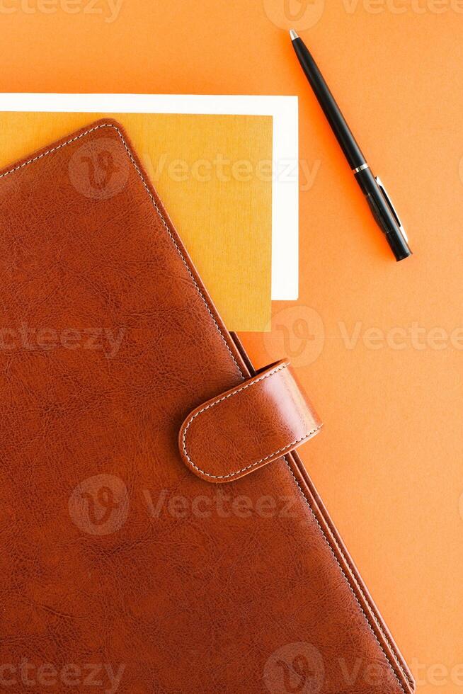 Luxury business brown brief-case on the office table desk, flatlay photo