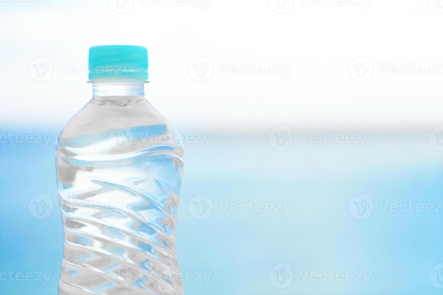 bottle of water on the beach - drinks, summertime and environment concept photo