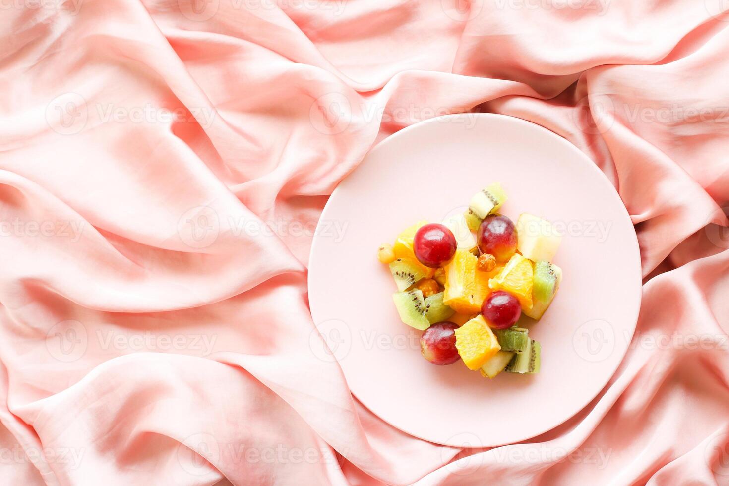 juicy fruit salad on silk, flatlay - healthy lifestyle and breakfast in bed concept photo