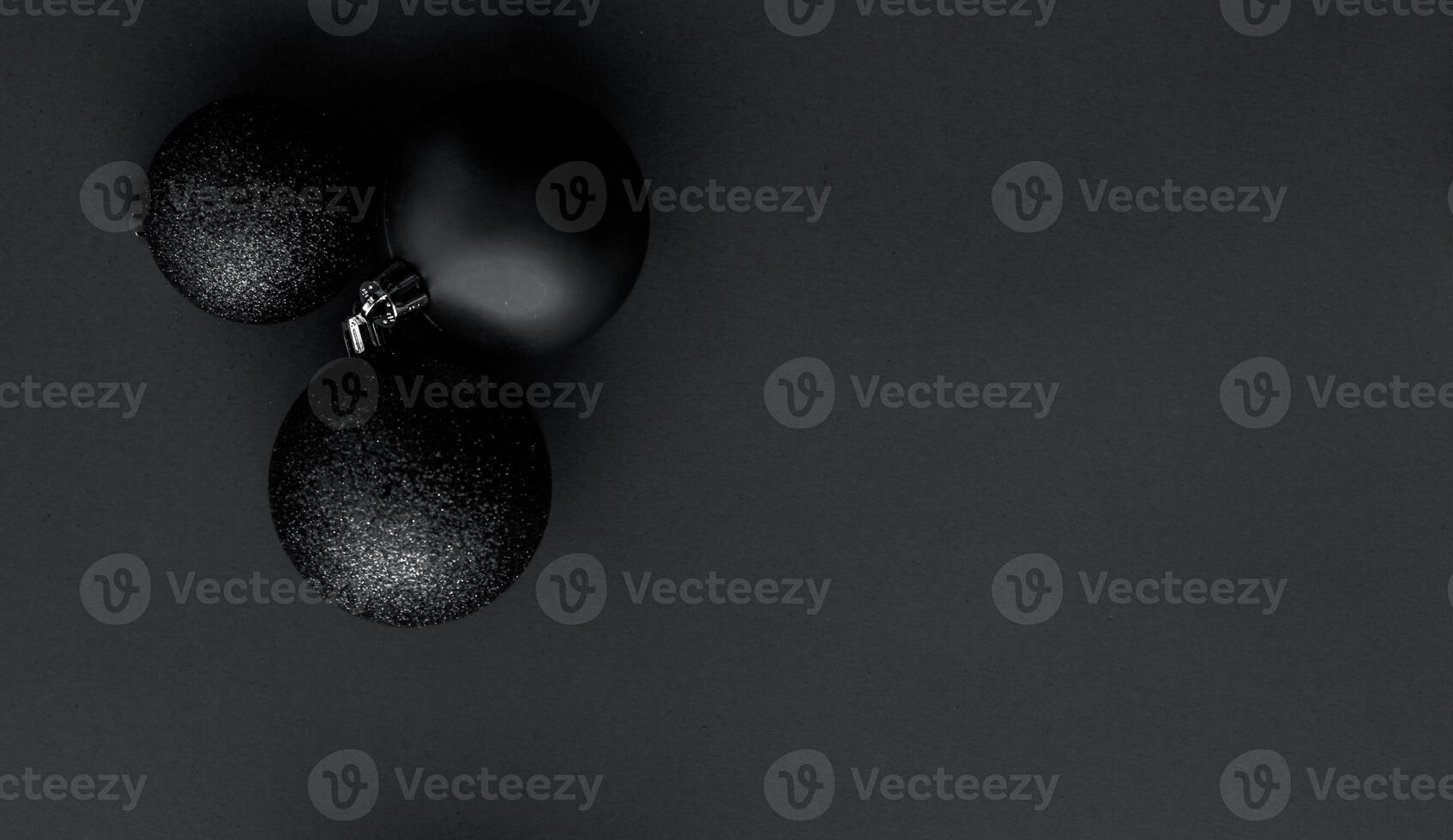Christmas baubles on black flatlay backdrop, luxury winter holiday card background photo