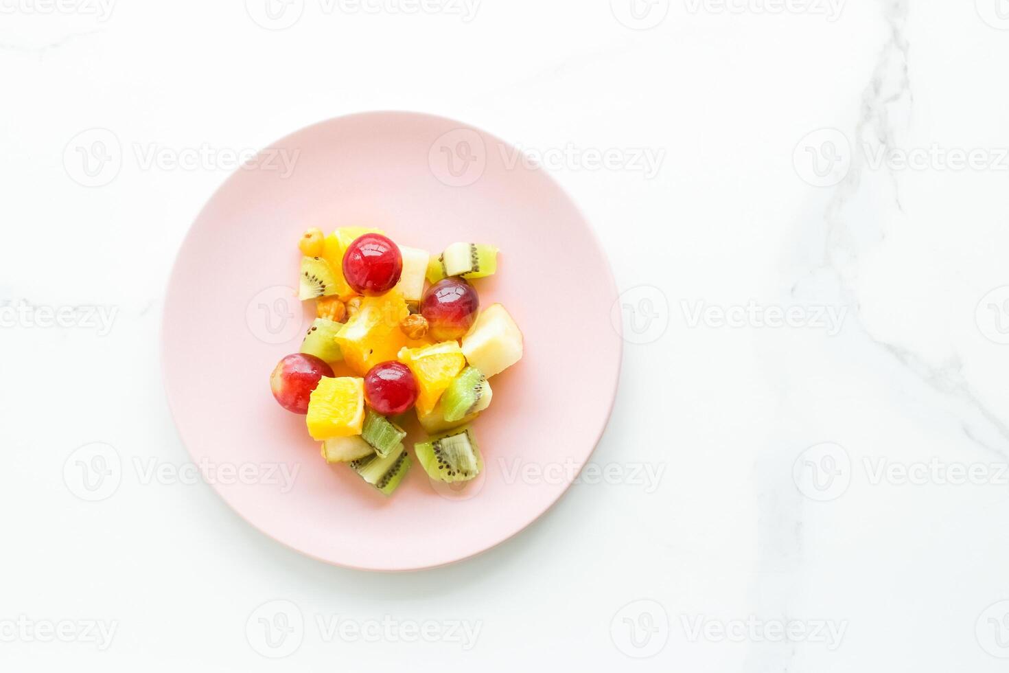 juicy fruit salad for breakfast on marble, flatlay - dieting and healthy lifestyle concept photo