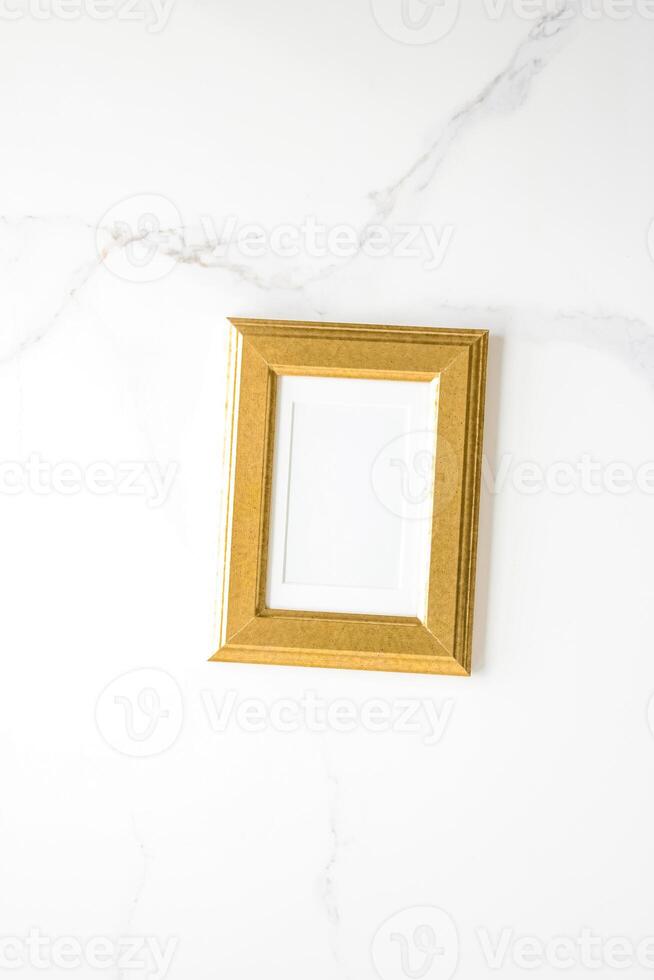 golden photo frame on marble, flatlay mockup - decor and mockup flatlay concept