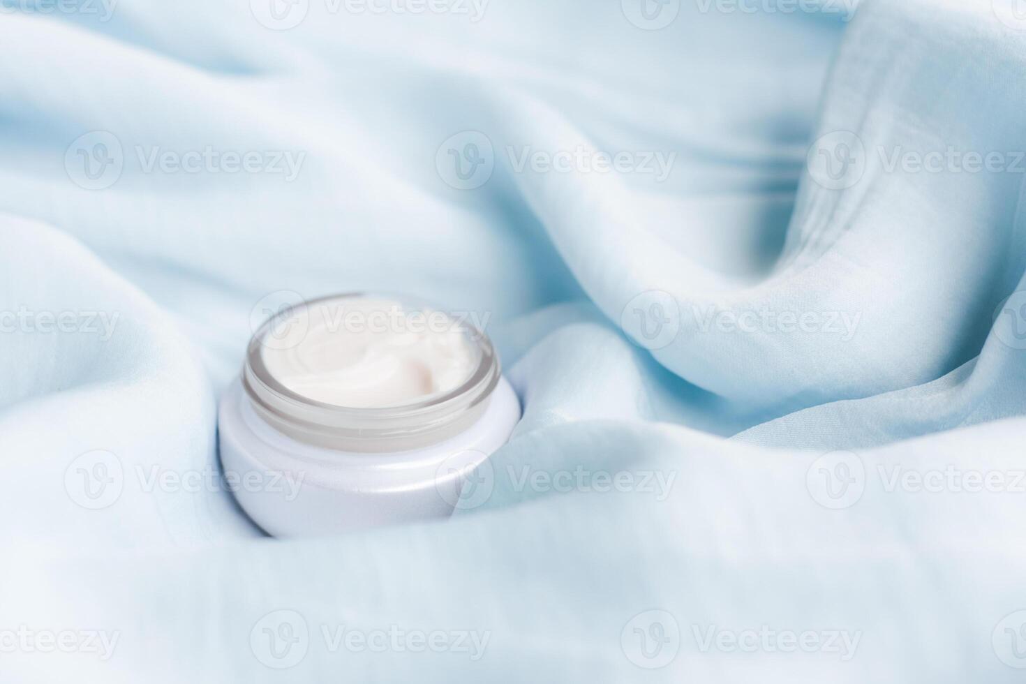 luxury face cream on soft silk - anti-aging, cosmetic and beauty styled concept photo