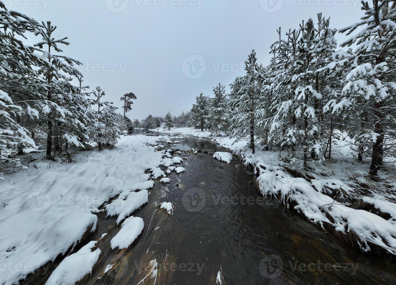 Amazing Cinematic Aerial View On Freezing River. Aerial View Flight Above Frozen Creek Scenic View Of Nature photo