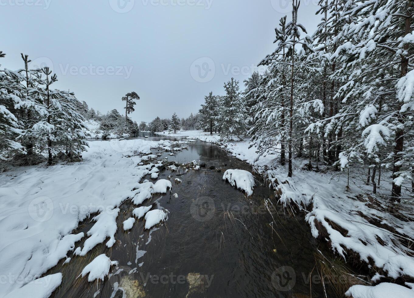 Amazing Cinematic Aerial View On Freezing River. Aerial View Flight Above Frozen Creek Scenic View Of Nature photo
