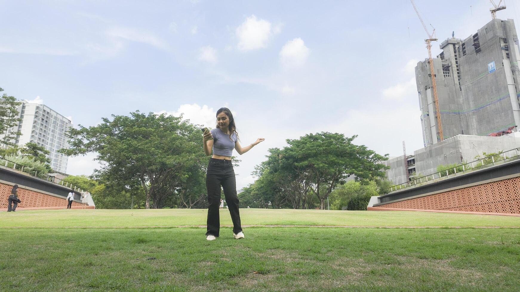 Asian women do freestyle hip hop and breakdancing in a public space in the middle of the city. With a cheerful and happy attitude photo